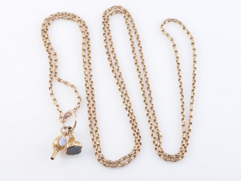 A 9 CARAT GOLD LONG CHAIN, with watch key and seal fob. Gross 28.6 grams