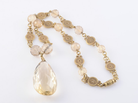 A CITRINE AND GILT METAL NECKLACE, the large faceted oval citrine drop...