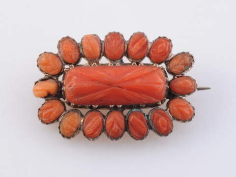 A CORAL BROOCH, circa 1880, the central rectangular carved coral plaque...