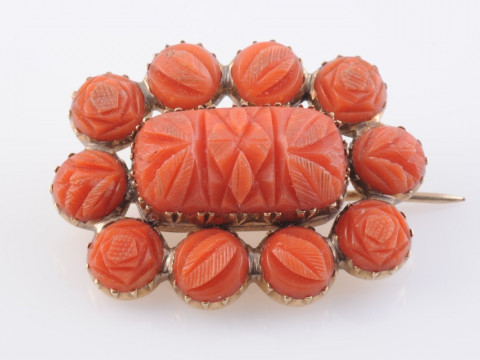 A CORAL BROOCH, circa 1880, the central rectangular carved coral plaque...