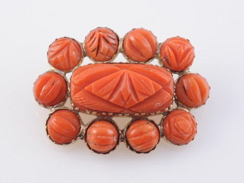A CORAL BROOCH, circa 1880, the central rectangular carved coral plaque...