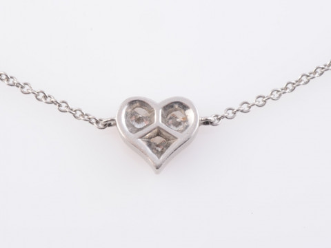 A DIAMOND AND PLATINUM BRACELET BY TIFFANY & CO, the simple heart shaped...