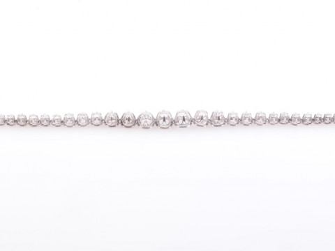 A DIAMOND BRACELET, the thirty-one graduating brilliant cut diamonds each...
