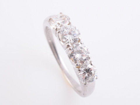 A DIAMOND RING BY KUTCHINSKY, the four brilliant cut diamonds each claw...