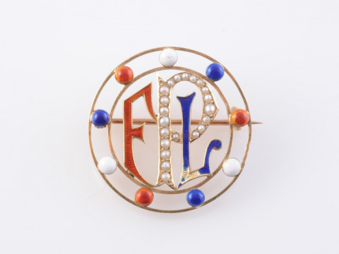 A GOLD AND ENAMEL BROOCH, the circular mount with beaded details of blue,...
