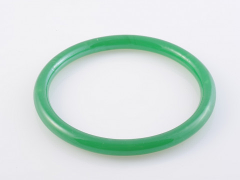 A JADEITE BANGLE, of simple polished form. Diameter 7.5cm. Weight 24.1gms.