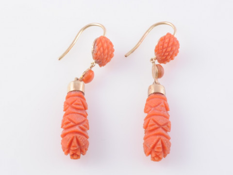 A PAIR OF CORAL EARRINGS, the carved tapering oval drop suspending on...