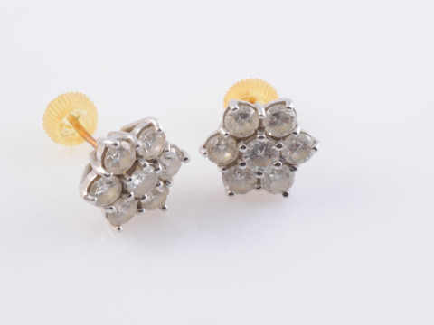A PAIR OF DIAMOND EARRINGS, the seven brilliant cut diamond each claw...