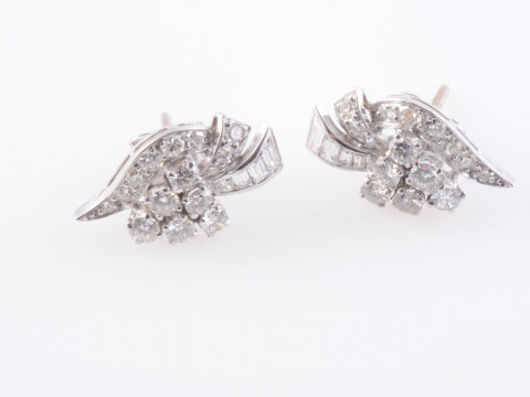 A PAIR OF DIAMOND STUD EARRINGS, the six brilliant cut diamonds each claw...