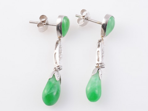 A PAIR OF JADEITE AND DIAMOND EARRINGS, the polished tapering oval jadeite...