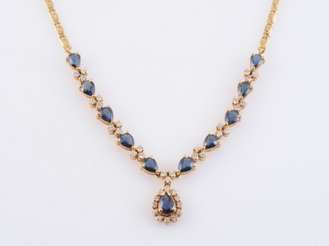 A SAPPHIRE AND DIAMOND BRACELET, the eighteen oval cut sapphires each...