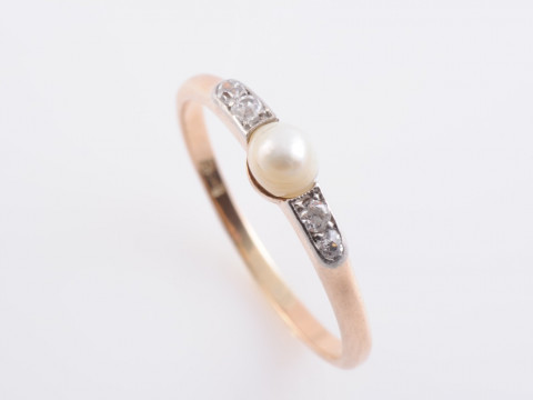 A SEED PEARL AND DIAMOND RING, the single seed pearl set between tapering...