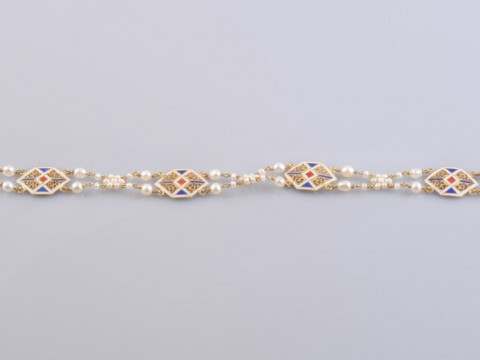 A SEED PEARL AND ENAMEL BRACELET, circa 1920, each square shaped plaque...