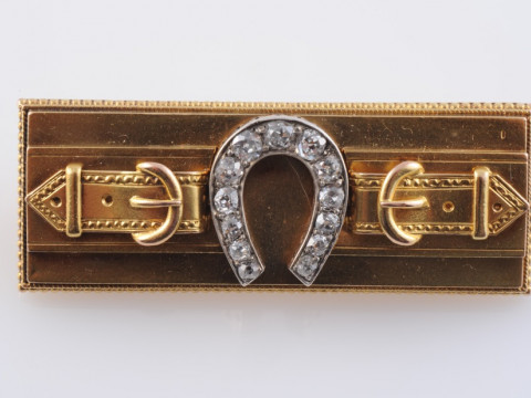 A VICTORIAN DIAMOND SET BROOCH, the rectangular plaque with subtle scrolling...