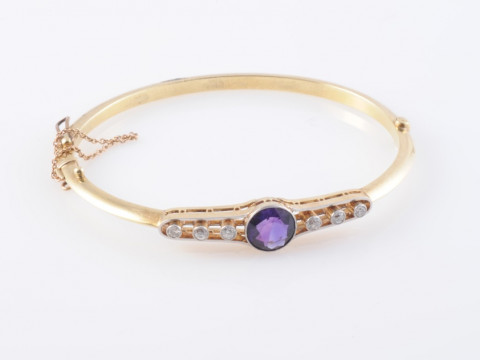 AN AMETHYST AND DIAMOND BANGLE, 1890-1900, the round cut amethyst millegrain...