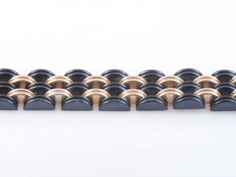 AN ART DECO BI COLOURED BRACELET, composed of interlinked and articulated...