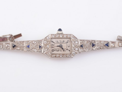 AN ART DECO PLATINUM, DIAMOND AND SAPPHIRE LADY'S COCKTAIL WATCH, the...