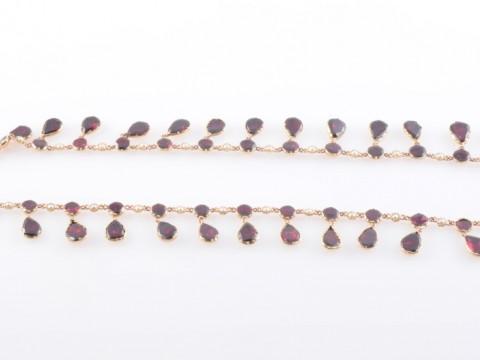 AN EARLY VICTORIAN GARNET AND SEED PEARL NECKLACE, the twenty-seven graduating...