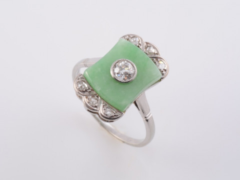 AN EDWARDIAN JADEITE AND DIAMOND RING, the square shaped jadeite plaque...