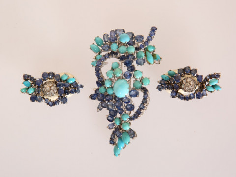 A TURQUOISE AND SAPPHIRE SPRAY BROOCH, the twenty eight graduating round...