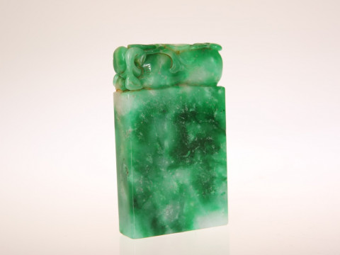 A CHINESE JADE CARVING, of fruit, on a seal-type base. Height 9cm