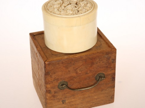A JAPANESE CARVED IVORY BOX, MEIJI PERIOD, of cylindrical form, the domed...