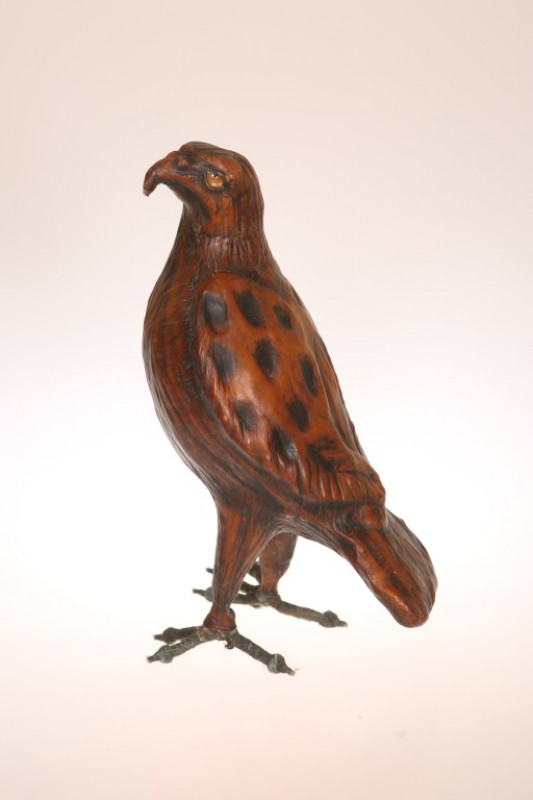 AN UNUSUAL LEATHER MODEL OF A HAWK, modelled standing upright. 32cm