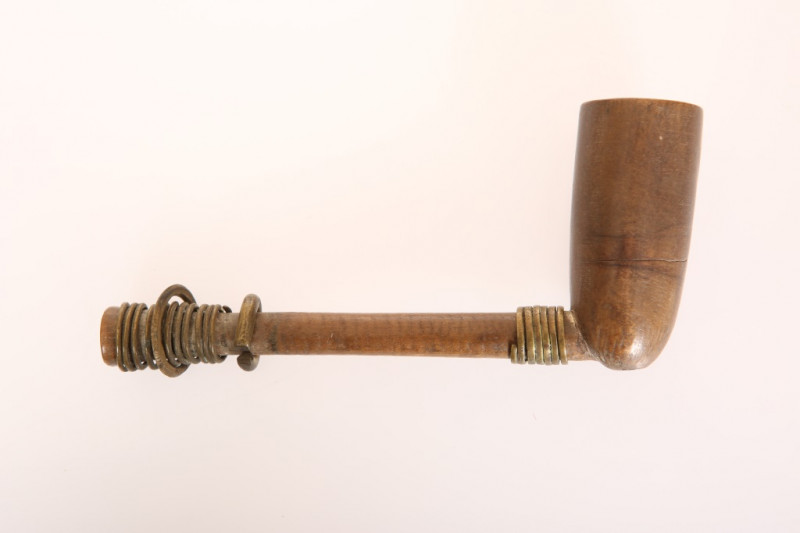 A WOODEN PIPE, POSSIBLY NATIVE AMERICAN, with tall funnel bowl, the stem applied with copper ring. Length 15.5cm