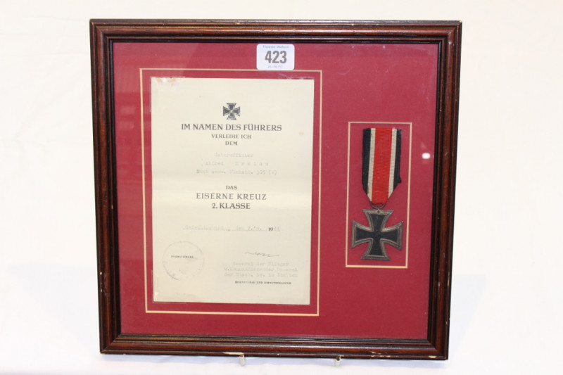 A GERMAN WORLD WAR II IRON CROSS, SECOND CLASS, to Unteroffizier Alfred Kreiss, mounted in a frame with original citation dated 7th October 1944, signed by the General commanding the German Air Force in Italy.
