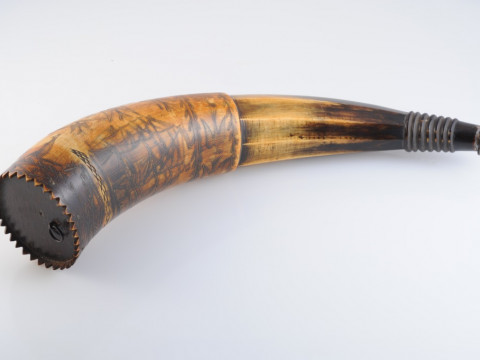 AN AUSTRALIAN POWDER HORN, with scrimshaw decoration of a ship in full sail, opposed by an inscription 'Presented to J. C. Low.....Jimbour, Queensland 1862' in a cartouche amidst birds and flags, inscribed with makers name Colvin or Corvin?. Length 33cm thumbnail