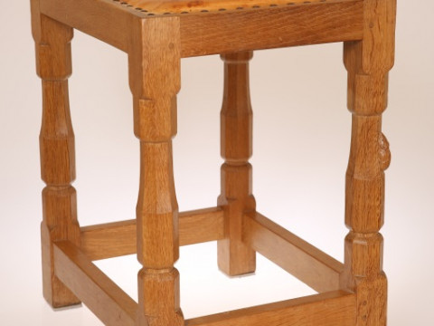 ROBERT THOMPSON OF KILBURN, A MOUSEMAN OAK STOOL, with leather top and...