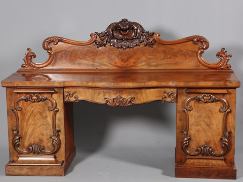 A WILLIAM IV MAHOGANY PEDESTAL SIDEBOARD, with boldly scrolling backboard...