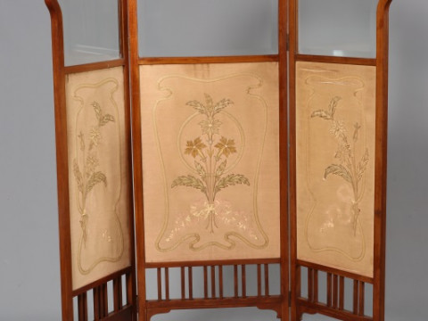 AN ART NOUVEAU MAHOGANY, FABRIC AND GLAZED SCREEN, CIRCA 1900, of three...