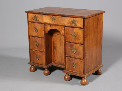 A WILLIAM & MARY STYLE WALNUT KNEEHOLE DESK, the moulded rectangular quarter...