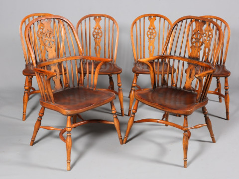 A SET OF SIX ELM WHEELBACK WINDSOR CHAIRS, including a pair of carvers,...