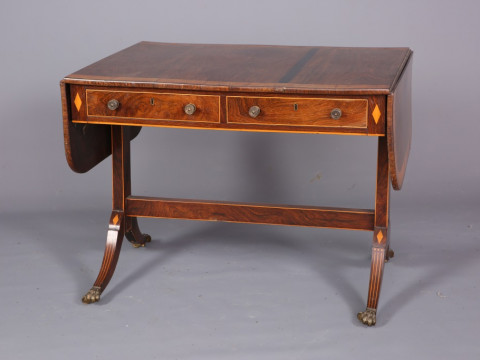 A REGENCY SATINWOOD AND ROSEWOOD SOFA TABLE, the crossbanded top with...