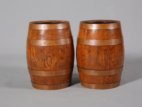 A PAIR OF COOPERED OAK BARRELS, with copper bands, early 20th Century....