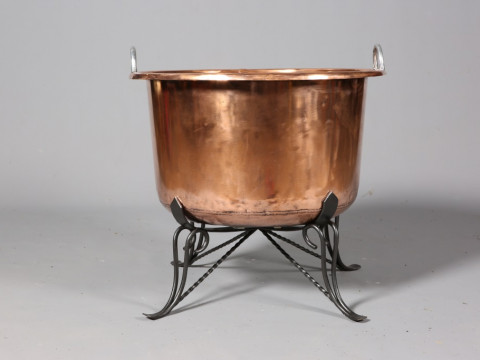 A LARGE POLISHED COPPER CHEESE KETTLE, with wrought iron stand. 67.5cm...