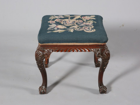 A 19TH CENTURY CARVED MAHOGANY AND NEEDLEWORK STOOL, with ball and claw...