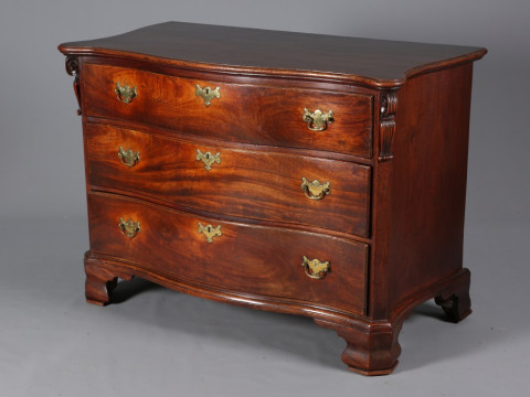 A GEORGE III MAHOGANY SERPENTINE CHEST OF DRAWERS, the moulded top above...