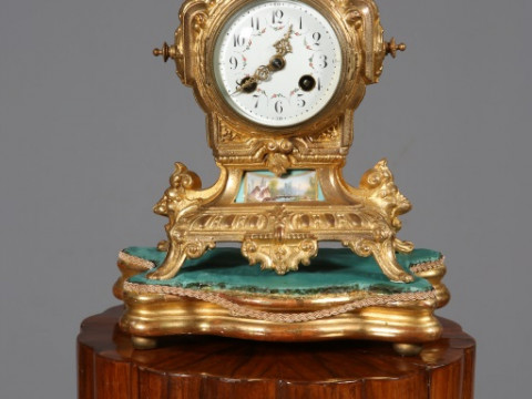 A FRENCH GILT-METAL MANTEL CLOCK, LATE 19TH CENTURY, the white enamel...