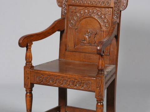 A 17TH CENTURY STYLE CARVED OAK WAINSCOT CHAIR, with planked seat and...