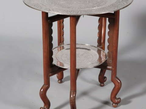 A CHINESE SILVERED METAL TWO TIER TRAY TABLE, mid-20th century, the larger...