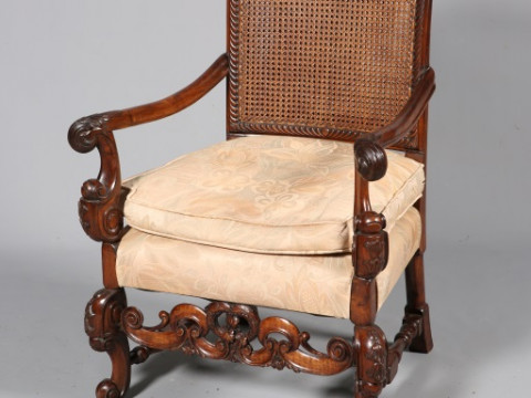 A CAROLEAN STYLE WALNUT ARMCHAIR, with double walled canework back and...