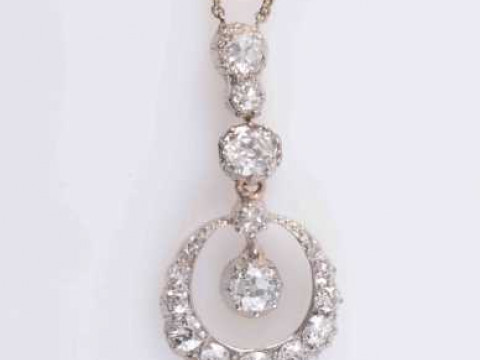 A DIAMOND PENDANT, circa 1880-1890, the open circular mount set with thirteen...