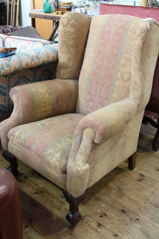 Georgian style wing armchair on carved cabriole ball and claw legs
