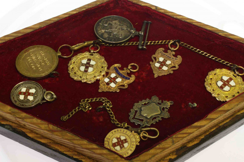 Collection of five 9 carat gold medals, two silver medals and two first world war medals, in glazed case