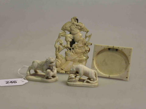 Two small ivory lion carvings, small frame and easeled relief carving...