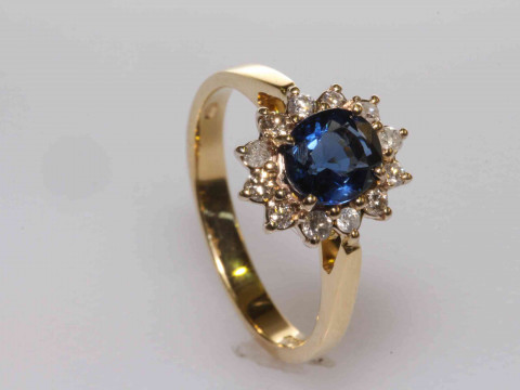 18 carat gold, oval sapphire and round brilliant cut diamond cluster ring,...