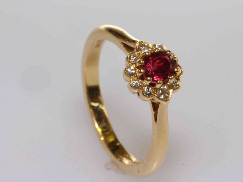 18 carat gold, oval ruby and round brilliant cut diamond cluster ring,...